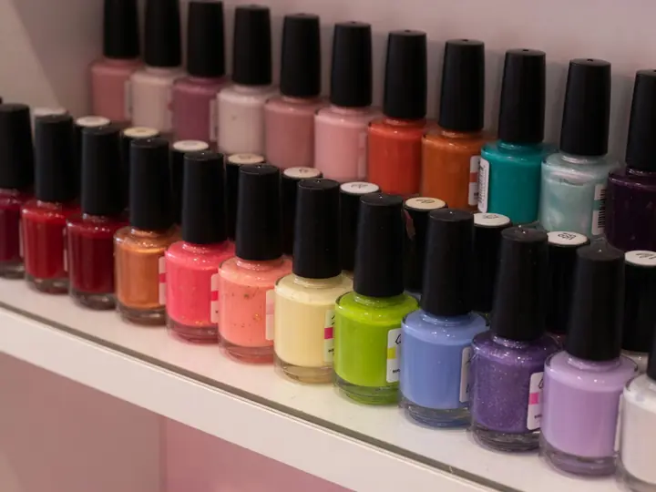 A rainbow row of nail polish bottles